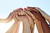 Cropped shot of a group of people joining hands in solidarity