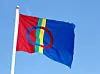The Sami flag isolated on clear blue sky.