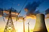 Nuclear power plant with wind turbines and electricity pylon in the sunset. Energy resources concept.