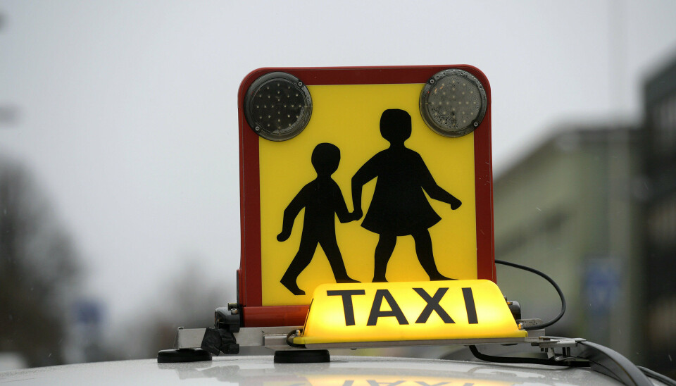 Taxichauffören som är misstänkt för sexuellt övergrepp mot barn kör inte längre skolskjutsar sedan skoldistriktet begärt att han tas ur trafik med anledning av misstankarna.